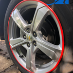 Red rim protector wheel guards on the edge of a Chevy Volt wheel for ATAM Auto.